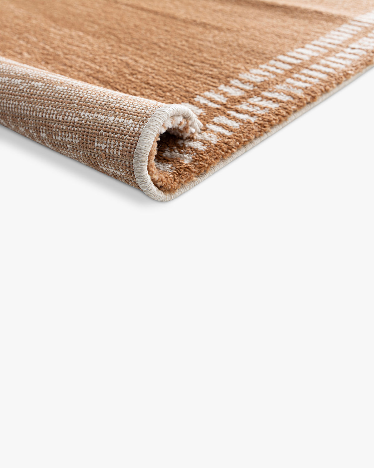 gros plan sur la densité du velours caramel et les tirets écrus d'un tapis Haven